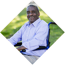 Man in a wheelchair smiling.